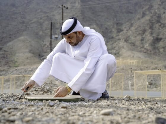 A participant working beside a planted tree in an image supplied with the Wadi Wurayah conservation announcement.