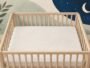 Illustrated empty cot with a clear, flat sleep surface.