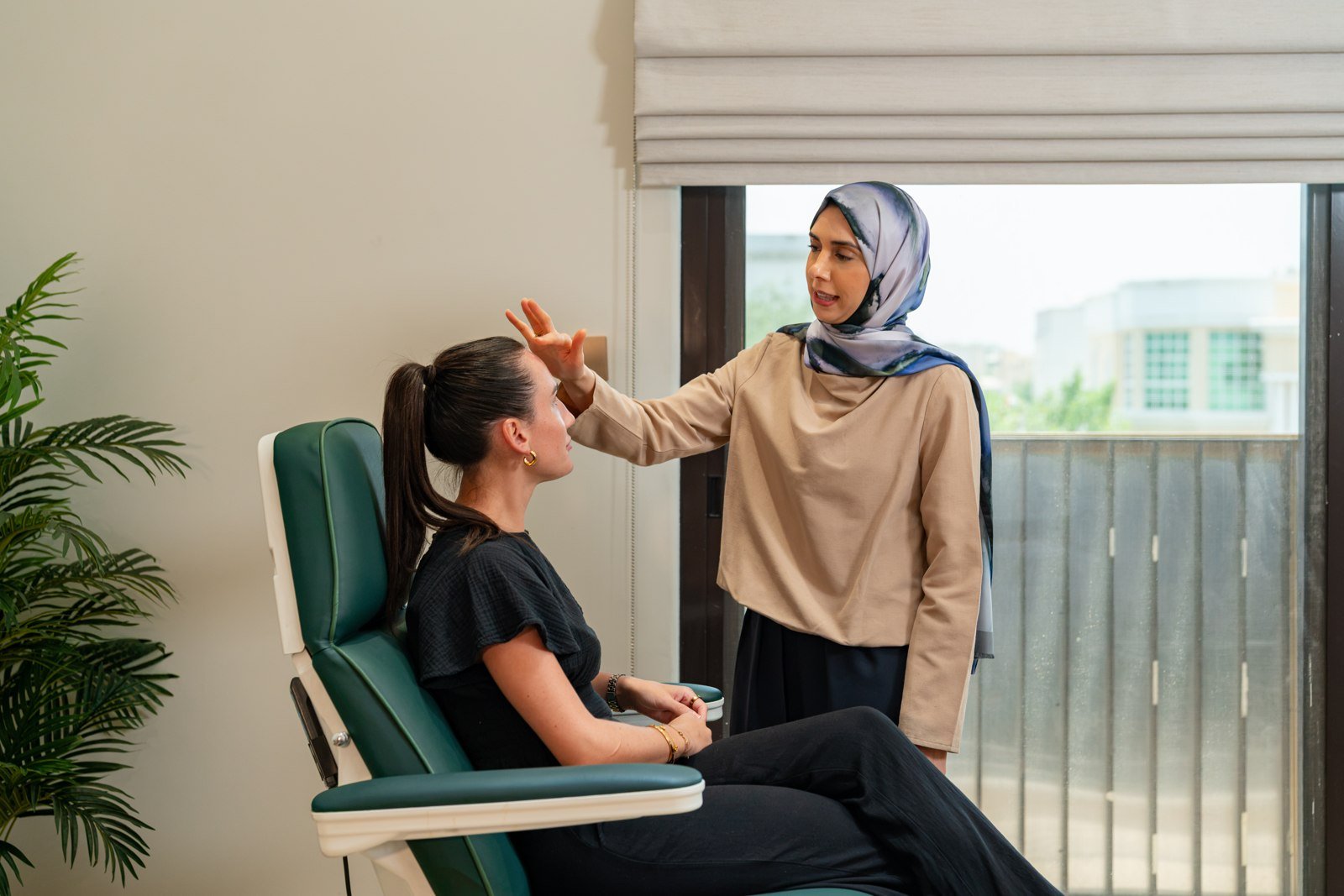A clinician speaking with a seated visitor in Sequoia Clinic’s supplied consultation photograph