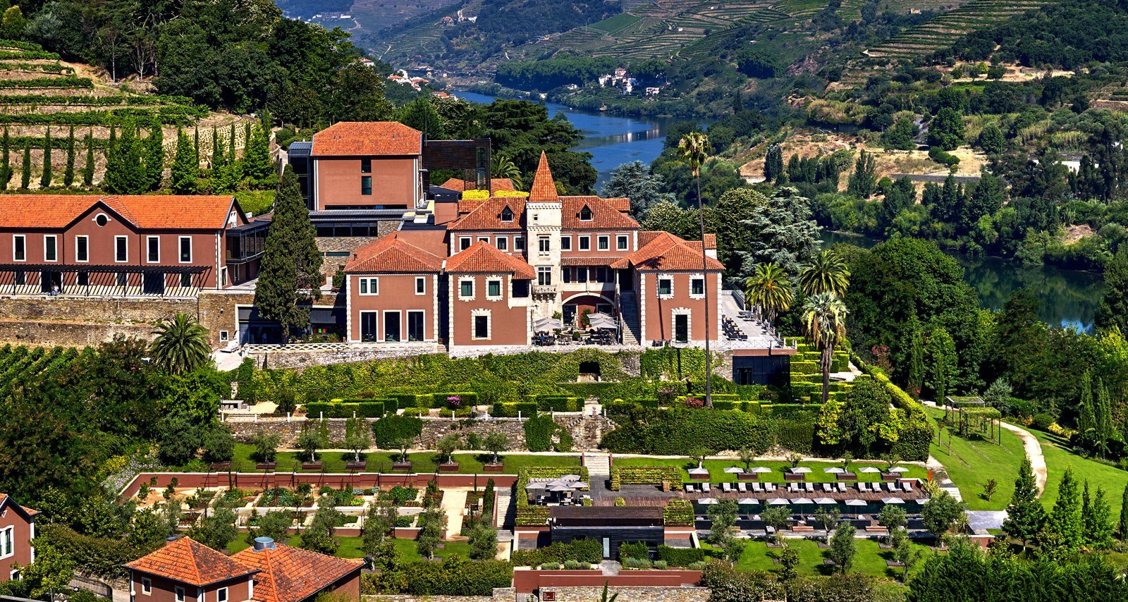 Six Senses Douro Valley buildings amid terraced vineyards above the river