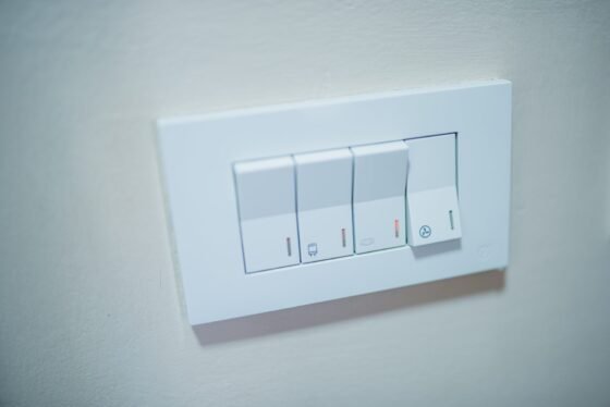 White physical light-control panel on a pale wall