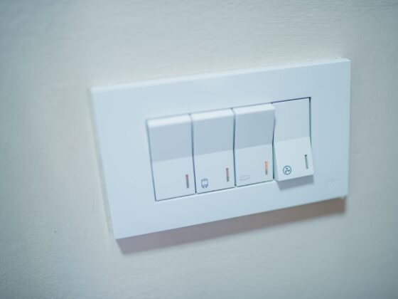 White physical light-control panel on a pale wall