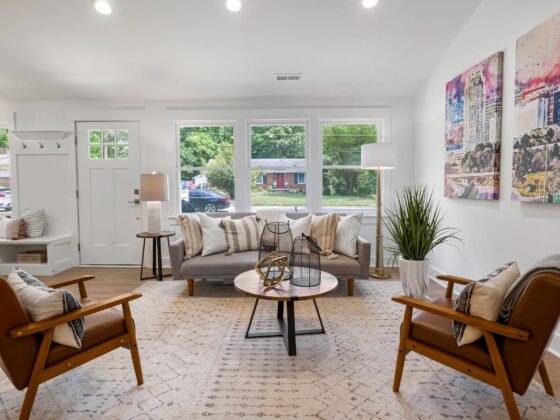 Bright living room with sofas, armchairs and windows