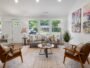 Bright living room with sofas, armchairs and windows